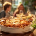 A family gathered around a table enjoying a large casserole dish of beefaroni, symbolizing comfort and togetherness.