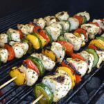 Grilled chicken skewers with vegetables on a barbecue